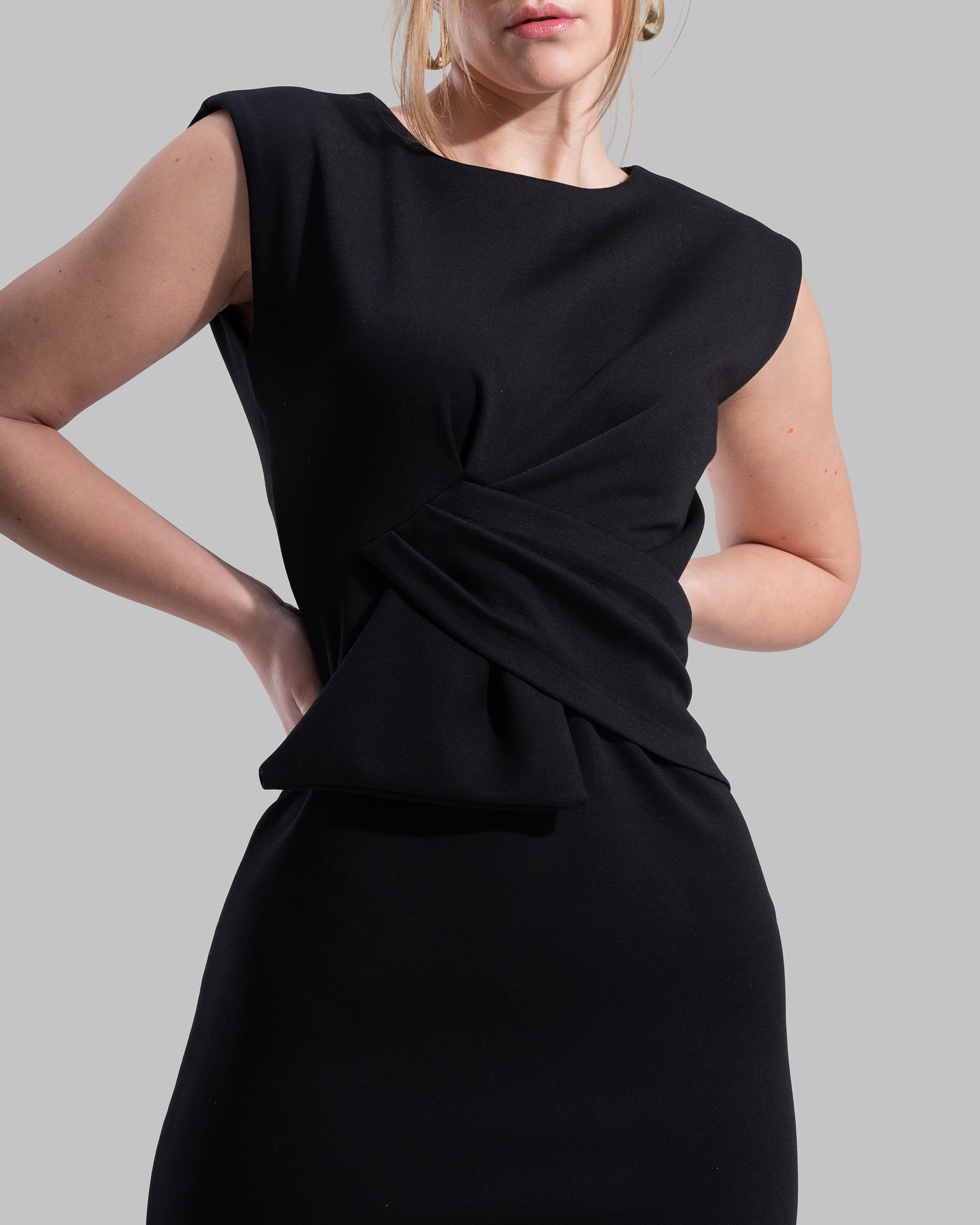 Sleeveless midi dress featuring a round neckline and front draped knot detail.