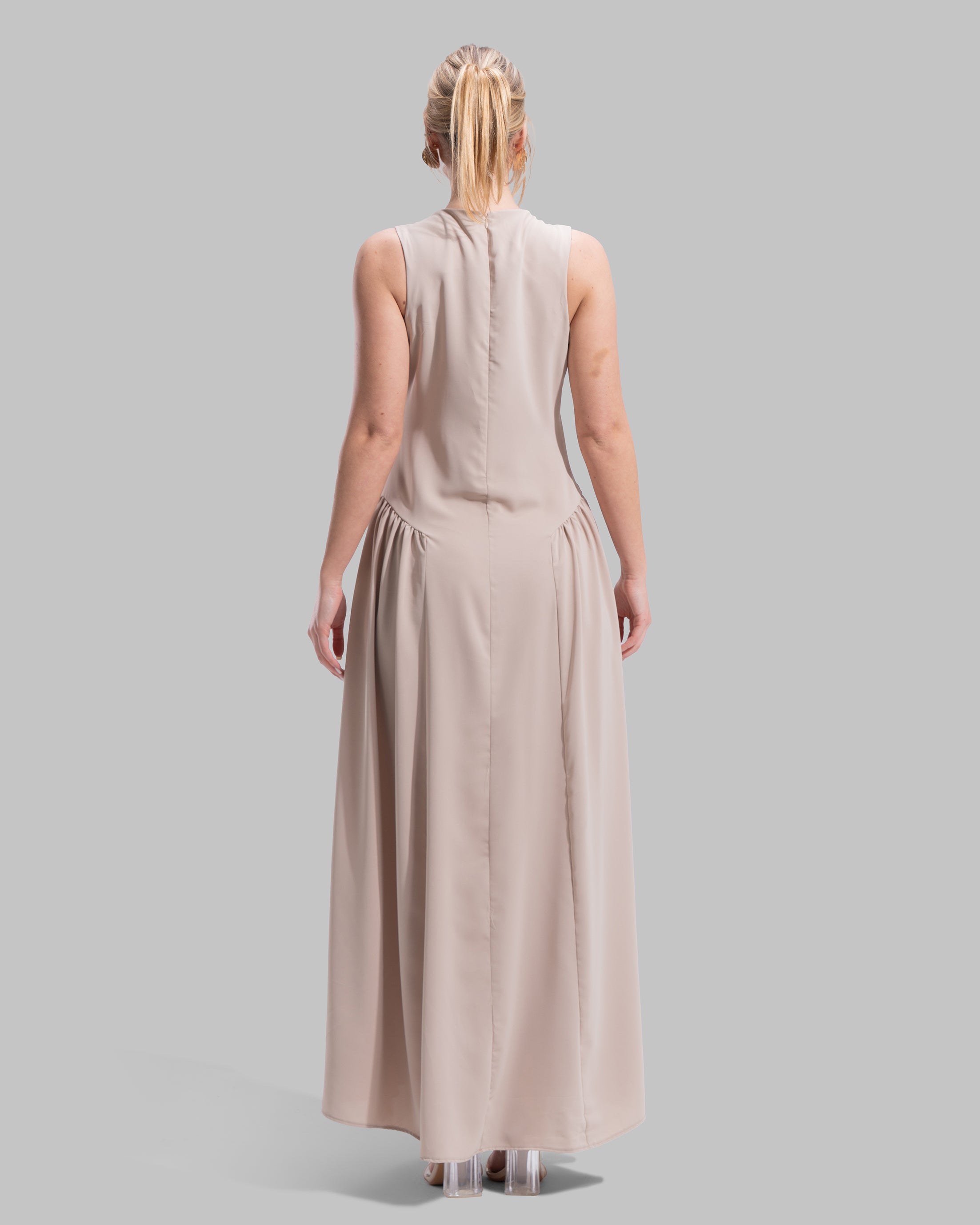 Sleeveless long dress with a round neckline.