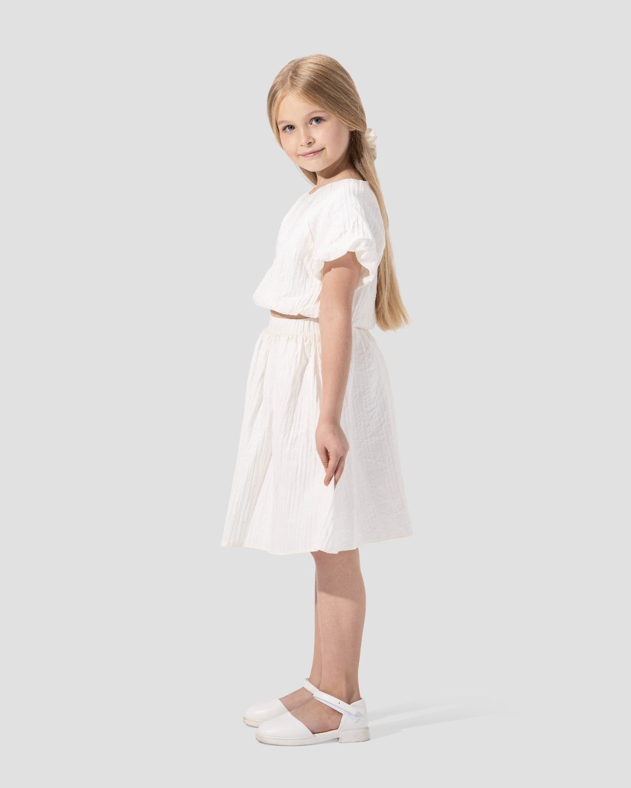 Textured puffy-sleeved top with a round neckline.