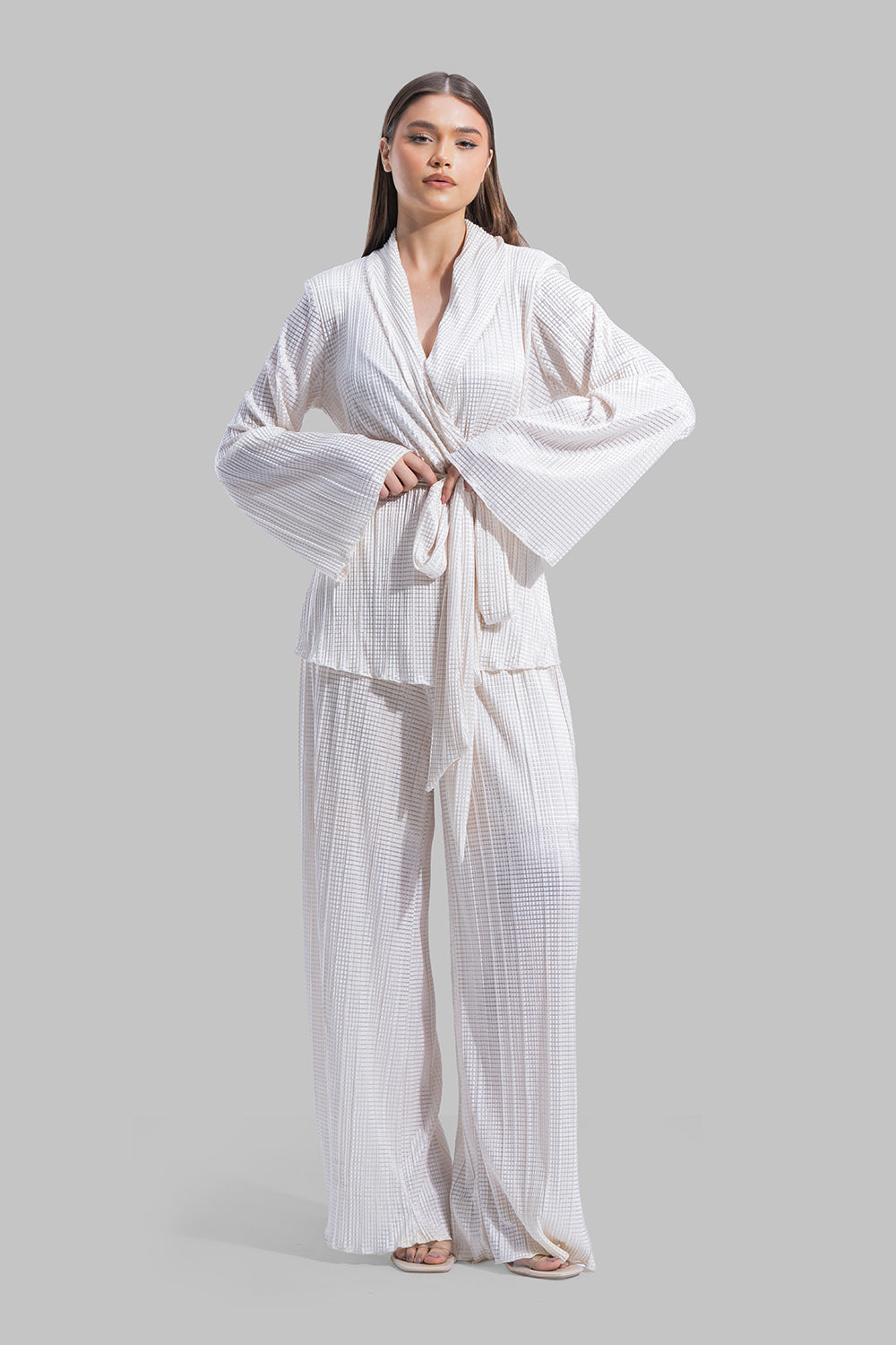 High-waisted wide-leg trousers with an elastic waistband and a textured plissé fabric.