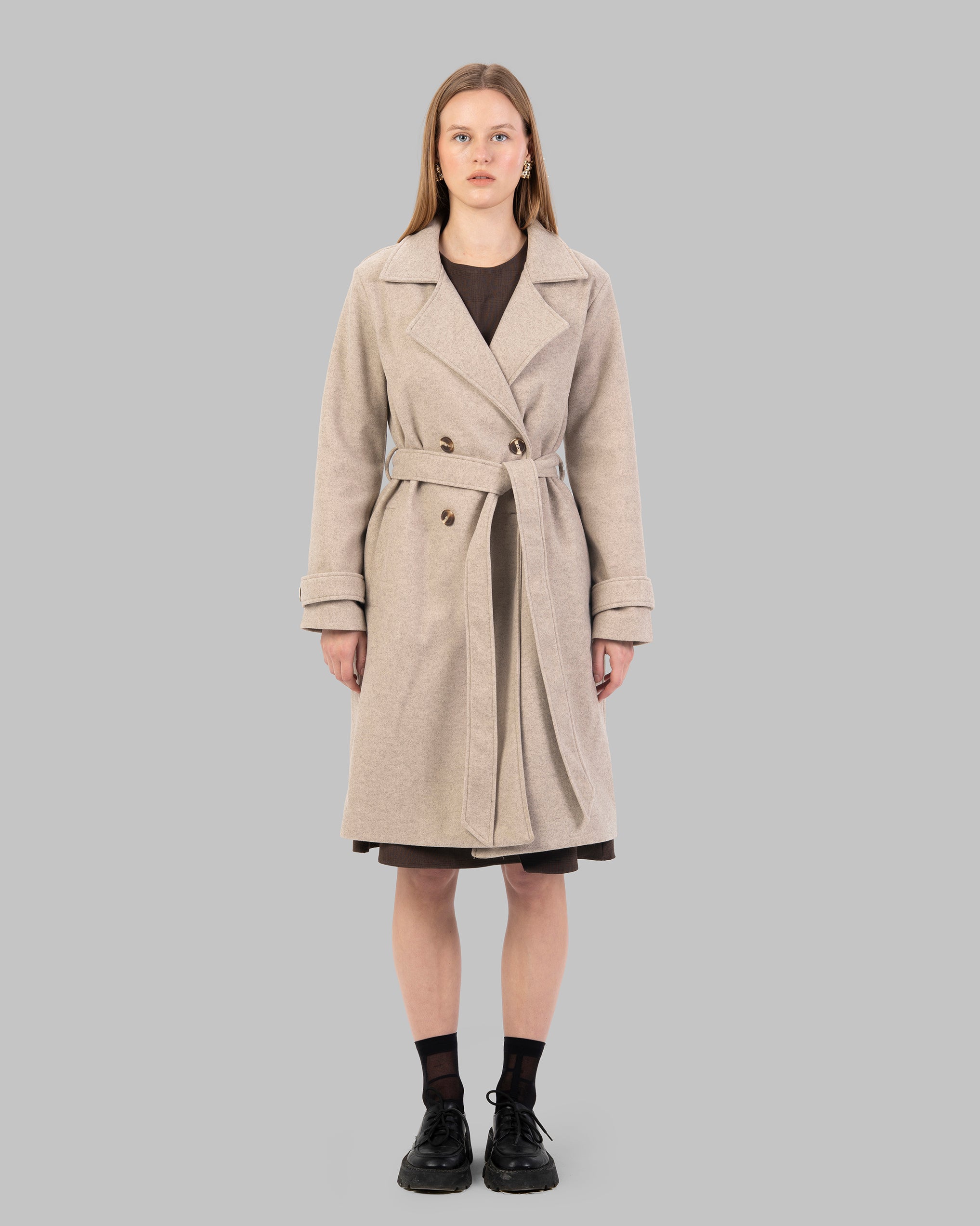 A classic light beige belted coat with a wide collar