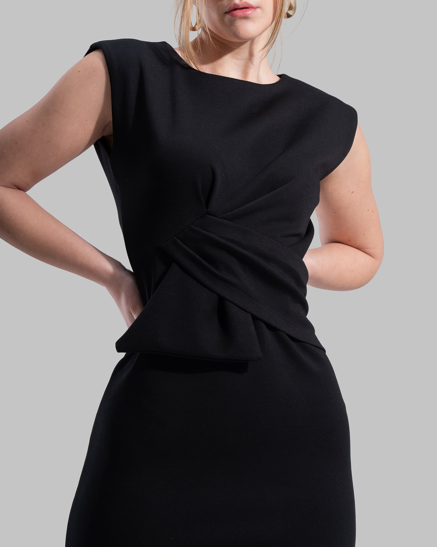 Sleeveless midi dress featuring a round neckline and front draped knot detail.