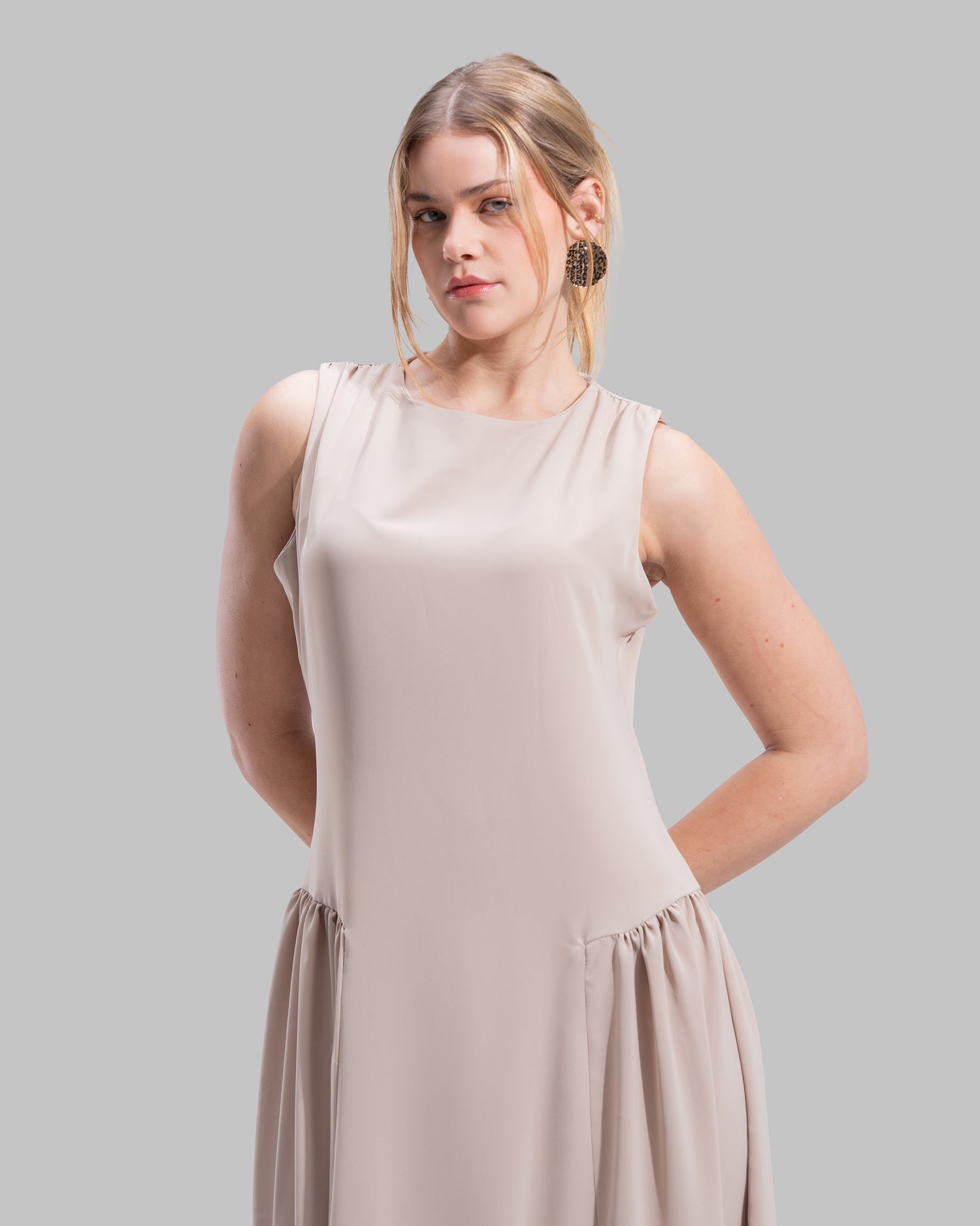 Sleeveless long dress with a round neckline.