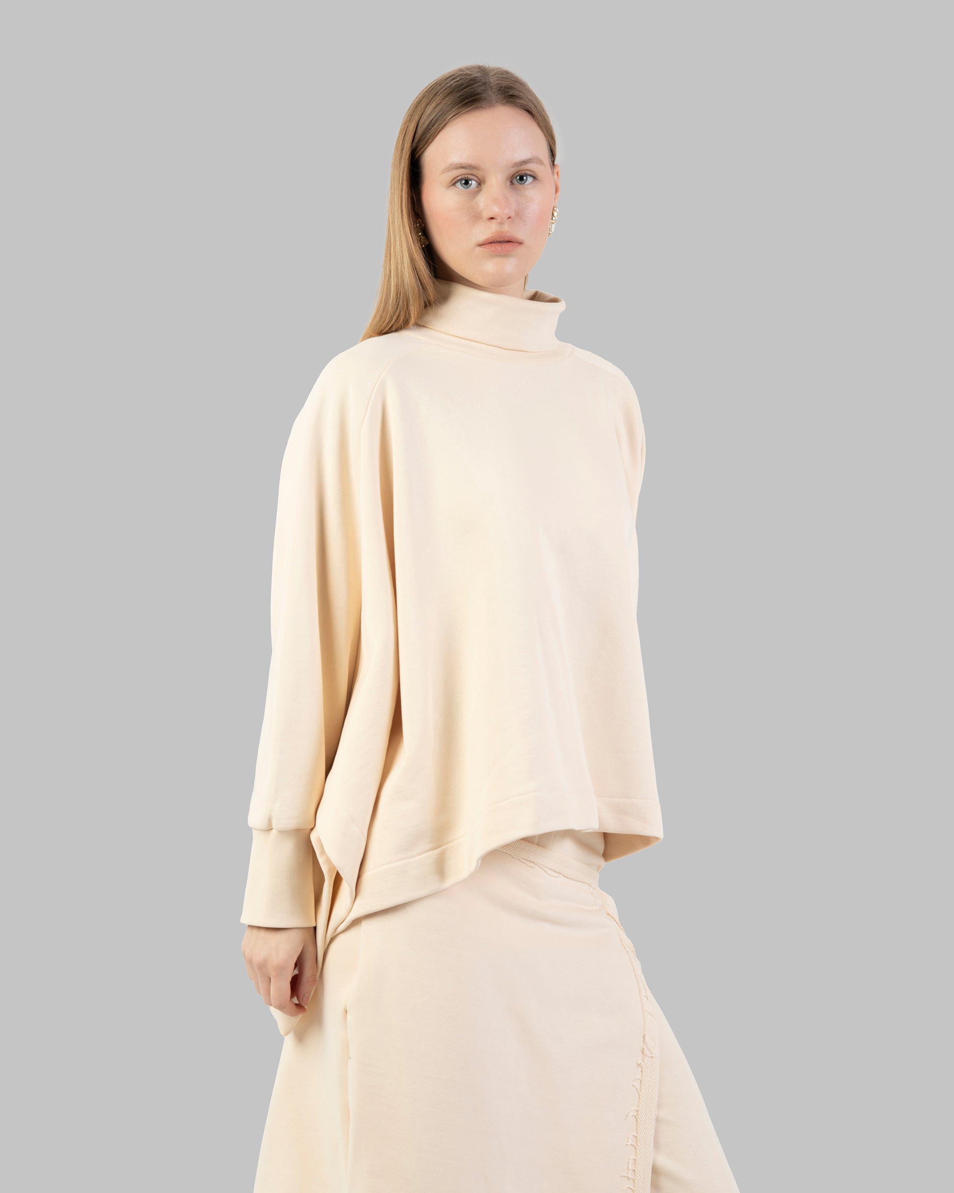 Loose-fit poncho-style top made of soft fabric.