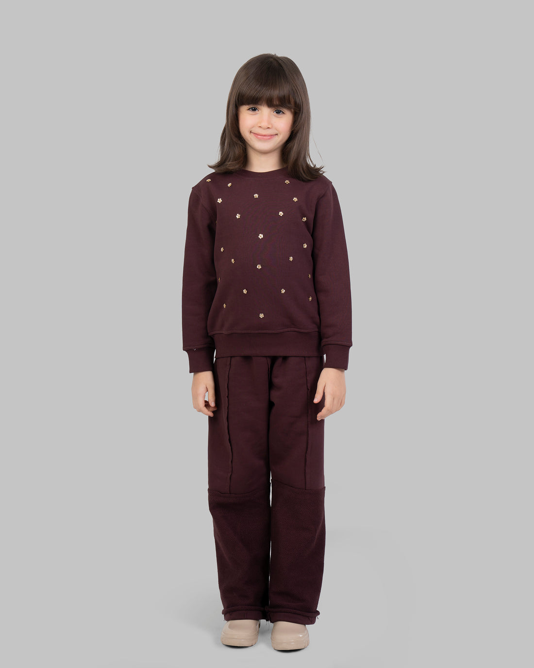 sweatshirt with small, scattered gold flowers on the front.