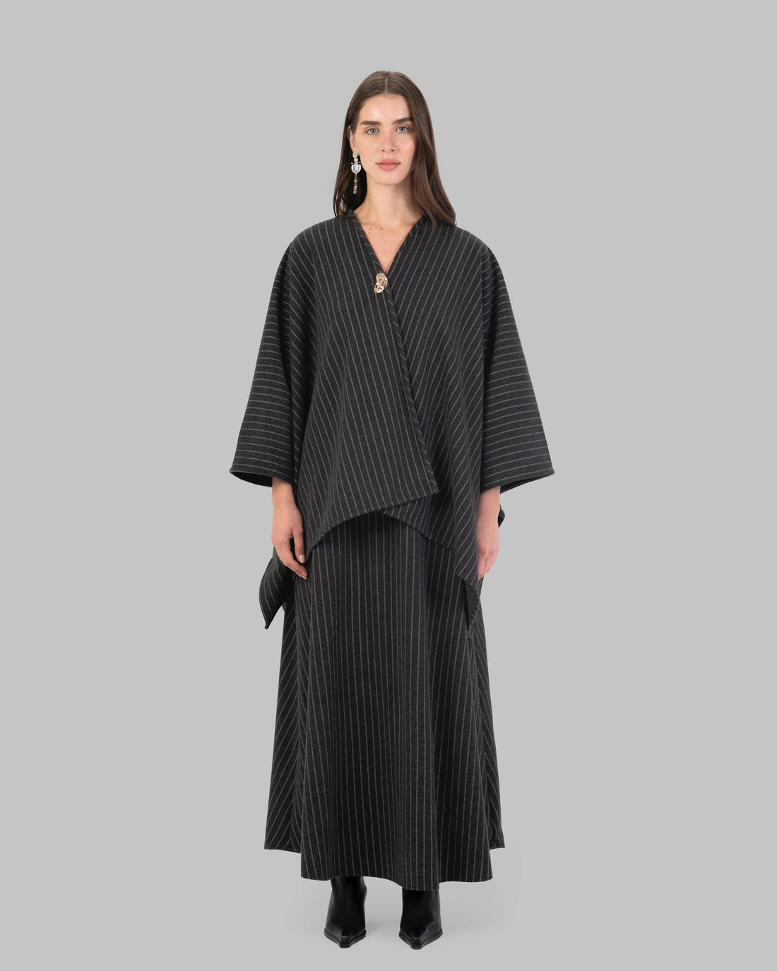 pinstripe poncho with a V-neck and an asymmetric hem.